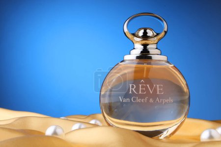 Photo for Perfume bottle .reve van cleef & arpels  with pearls over  silk background Flat lay and copy space top view. - Royalty Free Image