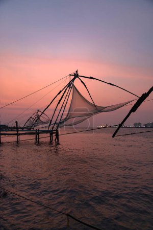 Photo for Sunset over Chinese fishing net at sunrise in Cochin Fort Kochi, Kerala, India - Royalty Free Image