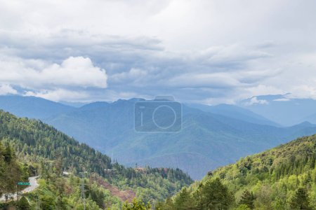 Photo for Landscape of the high mountain range at dirang arunachal pradesh northeastern India.The main highway under construction and maintenance through the hmalyas connecting assam with tawang as seen near dirang, arunachal pradesh, India. - Royalty Free Image