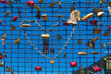 Photo for Cologne, Germany - May 29, 2011: lockers at the  Hohenzollern bridge symbolize love for ever in Cologne, Germany. It is the most heavily used railway bridge in Germany and used by pedestrians in love. - Royalty Free Image