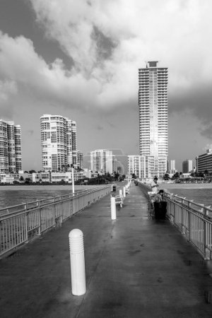 Photo for Sunny Isles Beach, USA - August 17, 2014: people catch fishes at  the pier in Sunny Isles Beach, USA. In 1936, Milwaukee malt magnate Kurtis built the Sunny Isles pier. - Royalty Free Image