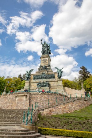 Photo for RUDESHEIM, GERMANY - APR 26, 2017: Tourist visiting the Niederwalddenkmal monument located in the Niederwald Landscape park, near Ruedesheim.. Rhine Valley is UNESCO World Heritage Site - Royalty Free Image