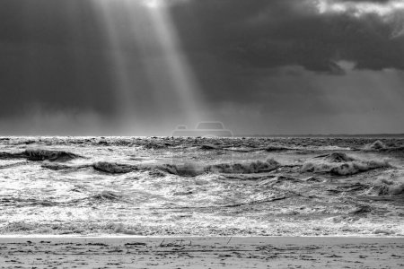 Photo for Sea landscape with huge waves and a lightbeam in Sylt, Germany - Royalty Free Image