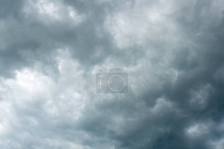 Photo for Pattern of dark clouds with partly blue sky gives a creepy mood - Royalty Free Image