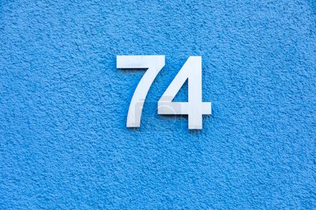 Foto de House number 74 wirth blue wall background in Germany - Imagen libre de derechos