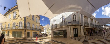 Foto de Faro, Portugal - October 3, 2020: old cobble stone street in the old town of Faro, Portugal, Algarve in panoramic view. - Imagen libre de derechos