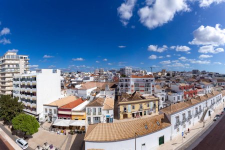 Foto de Faro, Portugal - October 3, 2020: view to old town of Faro, Portugal, Algarve with mixture of modern and old traditional architecture. - Imagen libre de derechos