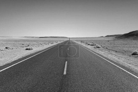 Photo for Driving on the Interstate 187 in Death valley direction Badwater in the heat of the Mojave Desert - Royalty Free Image