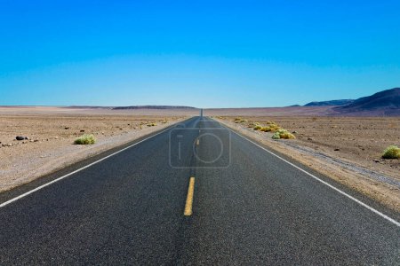 Photo for Driving on the Interstate 187 in Death valley direction Badwater in the heat of the Mojave Desert - Royalty Free Image