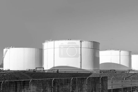 Photo for Tank farm in Germany with white oil and petrol silos under blue sky - Royalty Free Image