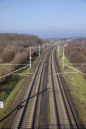 Téléchargez les photos : Rails with electrification for highspeed train in Germany under blue sky - en image libre de droit
