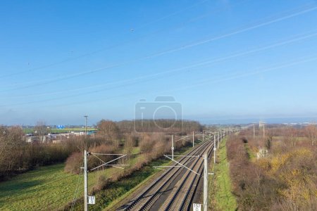 Photo for Rails with electrification for highspeed train in Germany under blue sky - Royalty Free Image