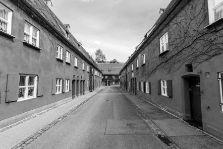 Photo for AUGSBURG, GERMANY - APRIL 29, 2015: The Fuggerei is the worlds oldest social housing complex still in use in Augsburg, Germany. - Royalty Free Image