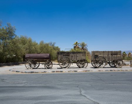 Photo for Death Valley, USA - July 19, 2008: old waggon at the entrance of the Furnance Creek Ranch in the middle of Death Valley, with these wagons the first men crossed the death valley in the 19th century - Royalty Free Image