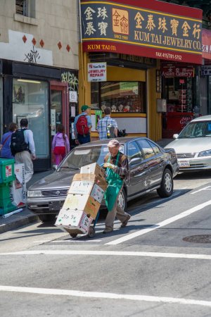Téléchargez les photos : San Francisco, États-Unis - 24 juillet 2008 : vue vers Chinatown à San Francisco avec un homme livrant du fret sur un chariot à sac. - en image libre de droit
