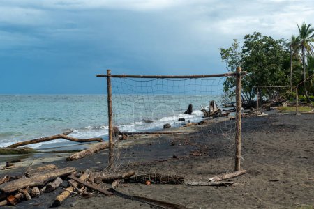 Photo for Scenic  beach of Cocles on the Caribbean side of Costa Rica, Puerto Viejo de Talamanca with an handmade soccer coal made of palm trees - Royalty Free Image