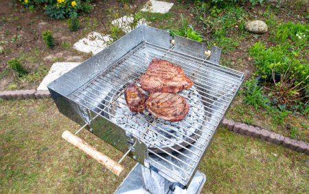 Photo for Steak at the hot grill in the garden - Royalty Free Image