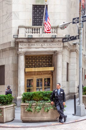 Photo for New York, USA - July 9, 2010: small separate entrance to the wall street stock exchange building, protected by a guard in uniform. - Royalty Free Image