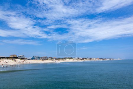 Photo for People enjoy bathing in Nags Head, USA. Established in the 1830s as first tourist colony. The first oceanfront cottage was built here around 1855 by Dr. W.G. Pool. - Royalty Free Image