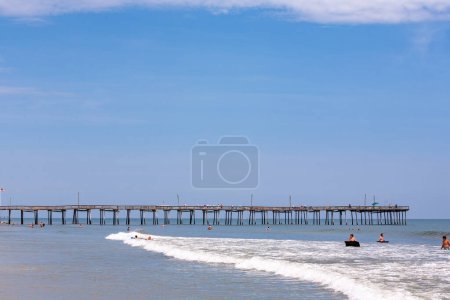 Photo for Nags Head, USA - July 18, 2010: people enjoy the old wooden pier beach at Nags Head, South Carolina. - Royalty Free Image