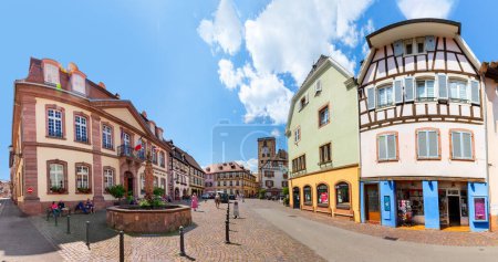 Téléchargez les photos : Ribeauville, France - 23 juin 2023 : Une rue pittoresque et colorée de bâtiments en bois avec commerces et cafés dans le village de Ribeauville, en Alsace. - en image libre de droit