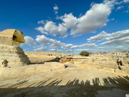 Photo for Full profile of Great Sphinx including pyramid in the background on a clear sunny, blue sky day in Giza, Cairo, Egypt with no people - Royalty Free Image