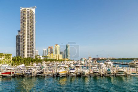 Photo for Scenic Miami skyline at daytime with blue sky and view to pier with motor boats - Royalty Free Image