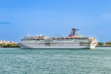 Photo for Miami, USA - August 18, 2014: Miami south beach with skyline and cruise ship carnival Ecstasy anchoring in the canal. - Royalty Free Image