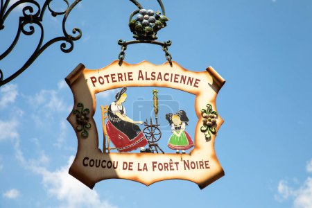 Photo for Kaysersberg, France - June 23, 2023: iron historic symbol and signage of an alsacienne potery with spinning wheel and name Coucou de la foret - engl: coucou of the black forest with pottery. - Royalty Free Image