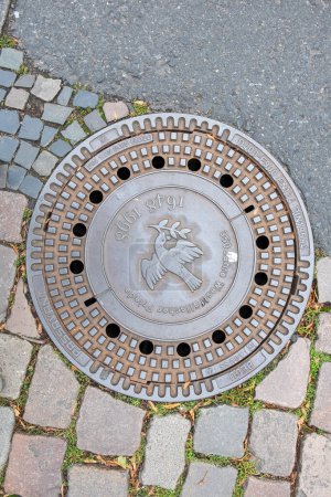 Photo for Muenster, Germany - August 5, 2023: water drain with inscription Westphalian peace - german :westpfaelischer frieden to honor the historic peace agreement in Muenster. - Royalty Free Image