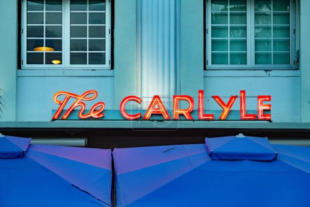 Photo for Miami, USA - August 20, 2014: neon signage the carlyle at the. famous art deco hotel at ocean drive. - Royalty Free Image