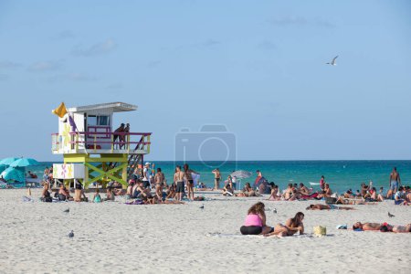 Photo for Miami Beach, USA - August 23, 2014: people enjoy the sunny day at south beach in Miami and return from a beach day, USA. - Royalty Free Image