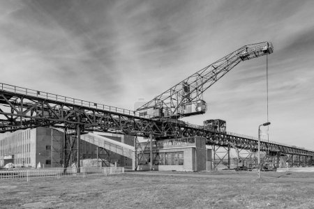 Photo for Peenemuende, Germany - April 17, 2014: historic conveior belt and crane to transport charcoal to the power plant to produce energy. - Royalty Free Image