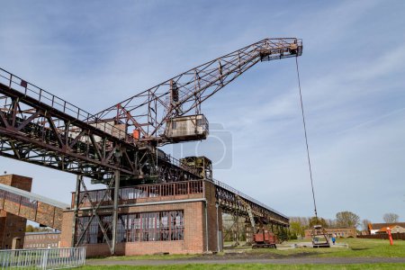 Photo for Peenemuende, Germany - April 17, 2014: historic conveior belt and crane to transport charcoal to the power plant to produce energy. - Royalty Free Image