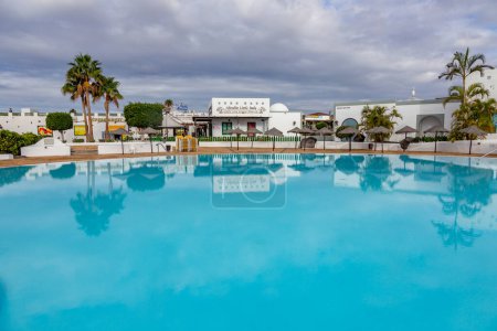 Photo for Playa Blanca, Spain - November 18, 2014: new harbor area i Playa blanca with pool, hotels, restaurants and shops. - Royalty Free Image