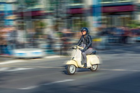 Photo for Berlin, Germany - October 27, 2014: man enjoys driving with his old historic motorbike called vespa in Berlin, Germany. - Royalty Free Image