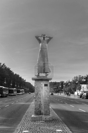 Photo for Berlin, Germany - October 27, 2014: statue of artist Gerald Marcks called the Rufer - calling man - with inscription Friede - peace at the street of the 17th july in Berlin. - Royalty Free Image