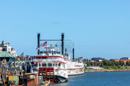 Photo for New Orleans, USA - October 24, 2023: Steamboat creole queen at the pier  at Mississippi River near the Monument To The Immigrant. The steamboat is still in Operation for touristic events. - Royalty Free Image