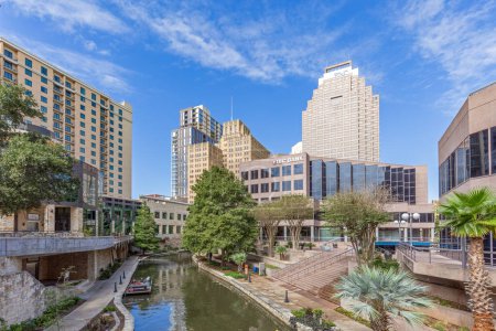 Photo for San Antonio, USA - October 31, 2023:   Famous Riverwalk in San Antonio iwith view to skyline in midday sun. - Royalty Free Image