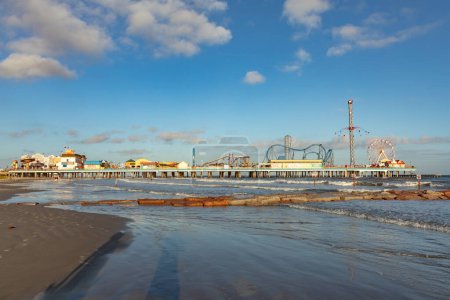 Photo for Galveston, USA - October 28, 2023: Pleasure Pier from the water in Galveston Island in afternoon light, Texas, USA. - Royalty Free Image