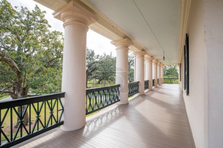 Photo for Vacherie, USA - October 27, 2023: balcony at oak alley Plantation in Vacherie, Texas. The plantation operated from operated from 1752-1975 and serves nowadays as a museum to show the history of slavery. - Royalty Free Image