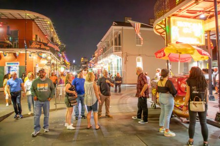 Photo for New Orleans; USA - October 24, 2023: people visit Pubs and bars with neon lights in the French Quarter, downtown New Orleans. - Royalty Free Image