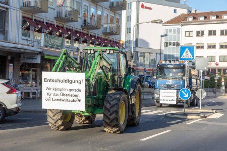 Photo for Wiesbaden, Germany - January 8, 2024: farmer with their tractors demonstrate for cutting down the price for diesel fuel and against the german government.with poster sorry, we fight for surviving. - Royalty Free Image