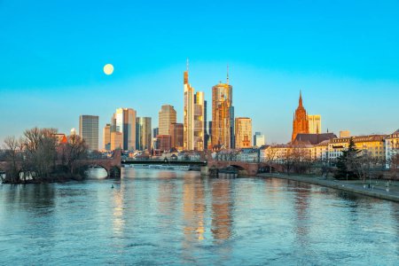 Photo for Scenic skyline of Frankfurt am Main in early morning with moon and reflection in the river, Hesse, Germany - Royalty Free Image