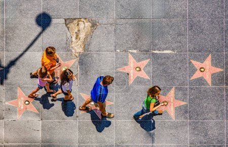 Photo for Los Angeles, USA- July 5, 2008: people passing the walk of fame in Hollywood on a sunny day in Los Angeles, USA - Royalty Free Image