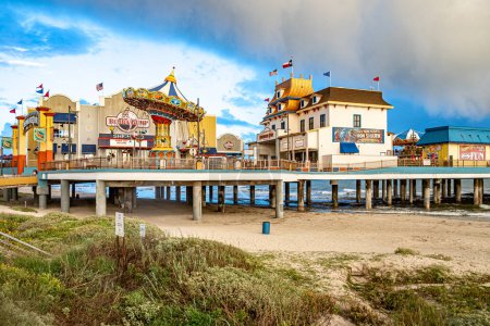 Photo for Galveston, USA - October 29, 2023: Pleasure Pier seen from the water in Galveston Island by bad weather conditions., Texas, USA. - Royalty Free Image