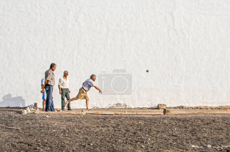 Photo for La Santa, Spain - August 4, 2007: erderly men at La Santa at the island of Lanzarote enjoy playing boule. - Royalty Free Image