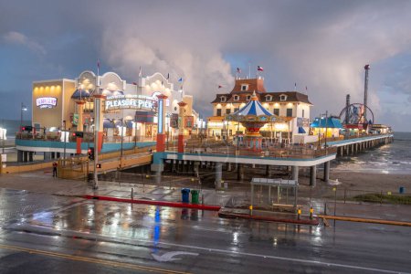 Photo for Galveston, USA - October 29, 2023: Pleasure Pier seen from the water in Galveston Island by bad weather conditions., Texas, USA. - Royalty Free Image