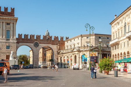 Photo for Verona, Italy - August 5, 2009: marble and red-brick gateway called Portoni della Bra with an impressive clock is leading to Pizza Bra in Verona, Italy. - Royalty Free Image