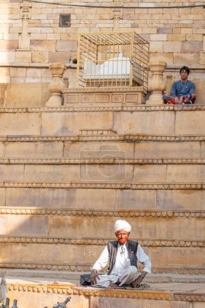 Photo for Jaisalmer, India - February 13, 2024: flute playing old man begging for alms at the Jaisalmer Fort, Rajasthan, India. - Royalty Free Image
